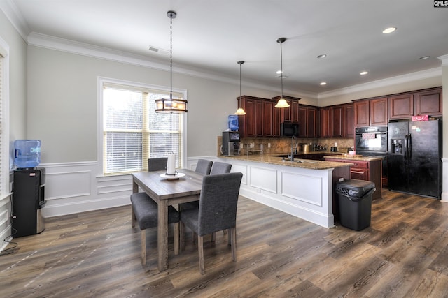 kitchen with decorative backsplash, black appliances, dark wood finished floors, and visible vents