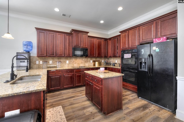 kitchen featuring visible vents, black appliances, a sink, tasteful backsplash, and dark brown cabinets