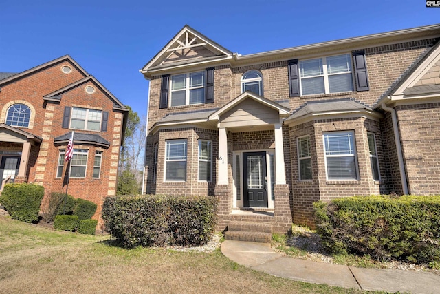 view of front of home with brick siding and a front lawn