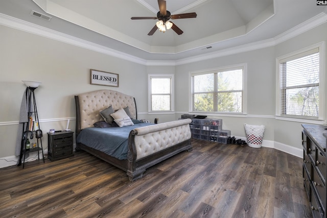 bedroom featuring visible vents, a raised ceiling, dark wood-style flooring, and crown molding