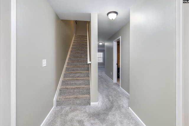 stairs featuring baseboards and carpet