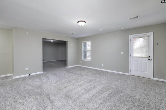 spare room with baseboards, visible vents, a wealth of natural light, and carpet floors