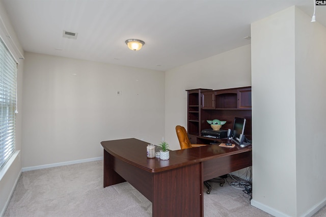 office area with baseboards, light carpet, and visible vents