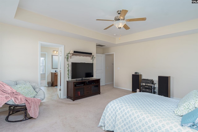 bedroom with visible vents, ceiling fan, baseboards, light carpet, and a raised ceiling