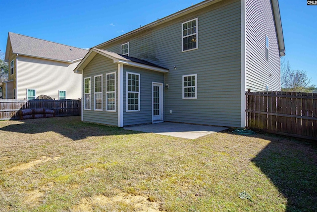 back of house with a patio area, a lawn, and a fenced backyard