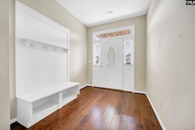 foyer featuring visible vents, baseboards, and dark wood finished floors