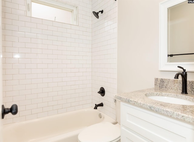 bathroom featuring vanity, toilet, and  shower combination