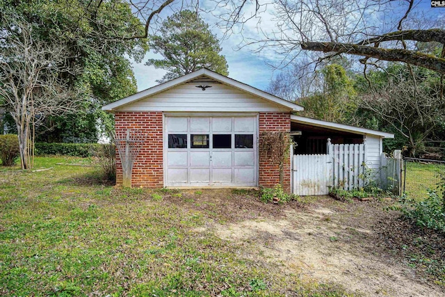 detached garage with driveway and fence