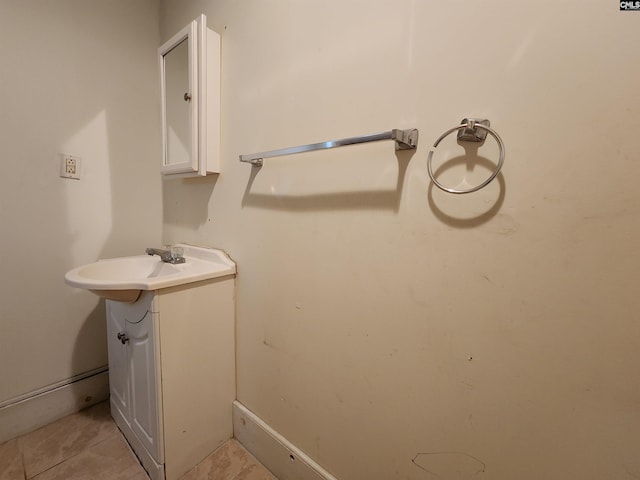 bathroom featuring tile patterned flooring and a sink