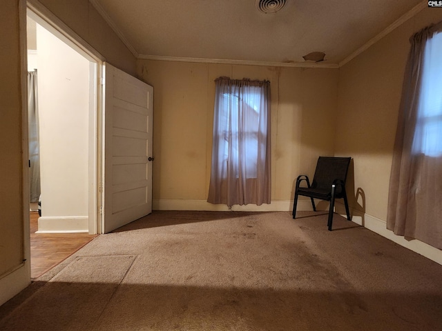 interior space with visible vents, baseboards, carpet floors, and ornamental molding