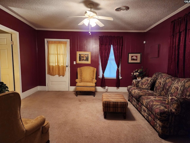 carpeted living area featuring visible vents, a textured ceiling, a ceiling fan, and ornamental molding