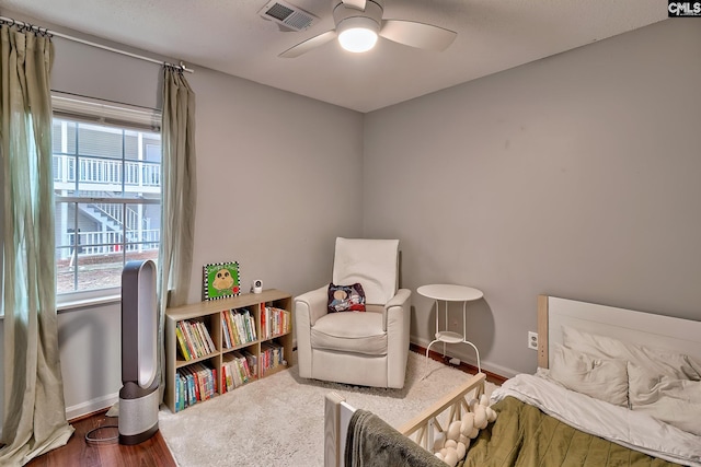 sitting room featuring baseboards, visible vents, and ceiling fan