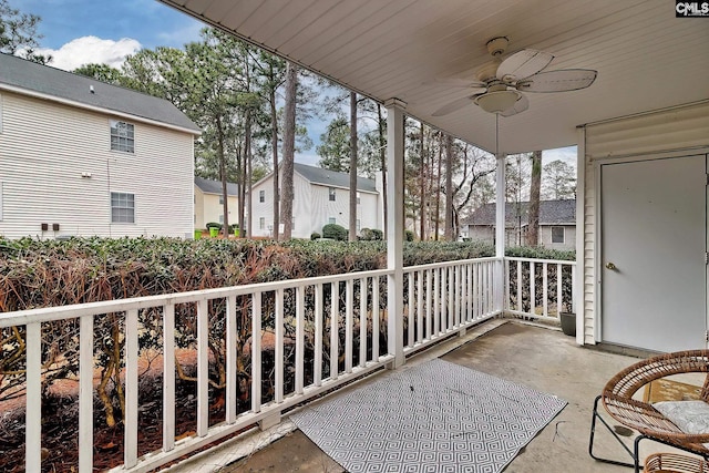 balcony with a residential view, a porch, and ceiling fan