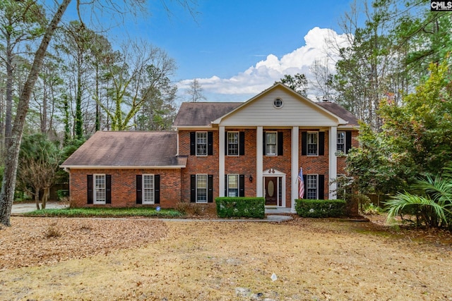 greek revival house featuring brick siding