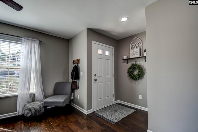 foyer with wood finished floors and baseboards