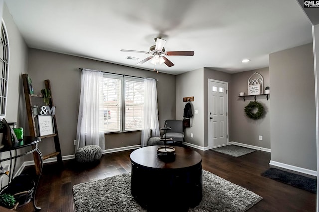 sitting room with a ceiling fan, wood finished floors, visible vents, and baseboards