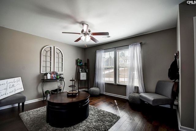 living area with visible vents, a ceiling fan, baseboards, and dark wood-style flooring