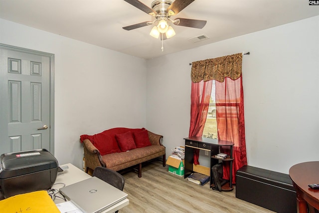 home office featuring visible vents, light wood finished floors, and ceiling fan