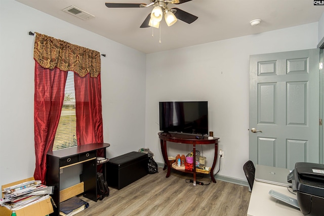 office with baseboards, a ceiling fan, visible vents, and light wood-type flooring