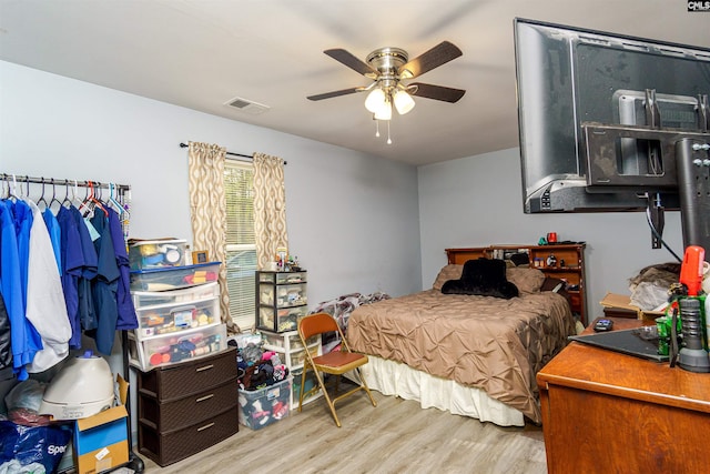 bedroom featuring visible vents, ceiling fan, and wood finished floors