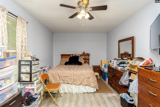 bedroom featuring a ceiling fan and wood finished floors