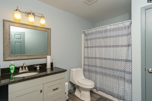 bathroom with vanity, wood finished floors, visible vents, curtained shower, and toilet