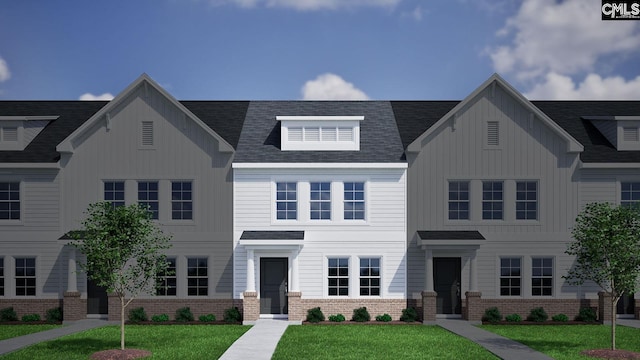 multi unit property with roof with shingles, board and batten siding, and a front lawn