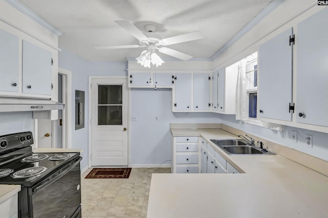 kitchen with under cabinet range hood, light countertops, black electric range, white cabinetry, and a sink