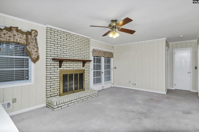 unfurnished living room featuring visible vents, a fireplace, and crown molding