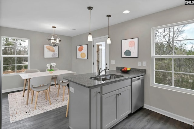 kitchen featuring dishwasher, a wealth of natural light, a peninsula, dark wood-style floors, and a sink