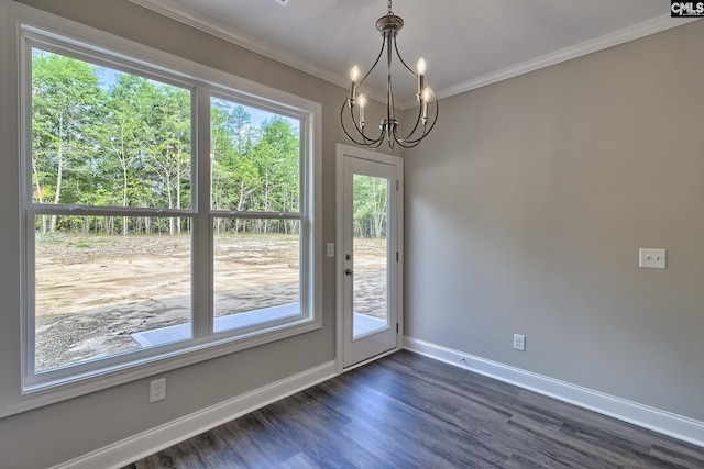 interior space featuring baseboards, a notable chandelier, dark wood finished floors, and crown molding