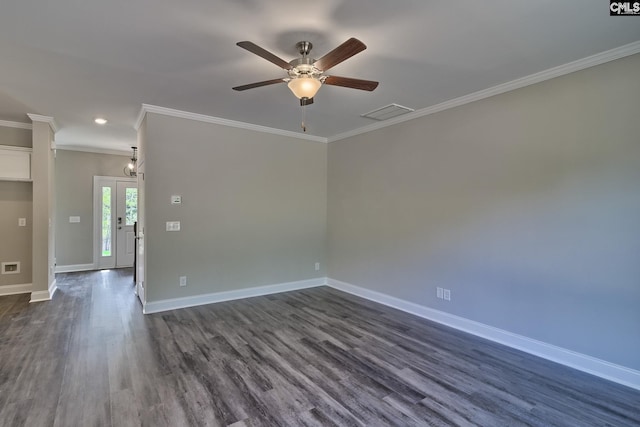 spare room with visible vents, dark wood-type flooring, crown molding, baseboards, and ceiling fan