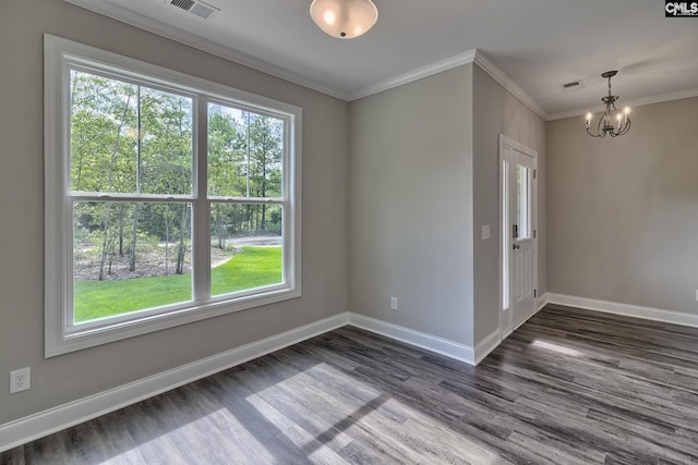 unfurnished room featuring baseboards, visible vents, and ornamental molding