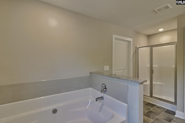 full bathroom featuring visible vents, a garden tub, and a stall shower