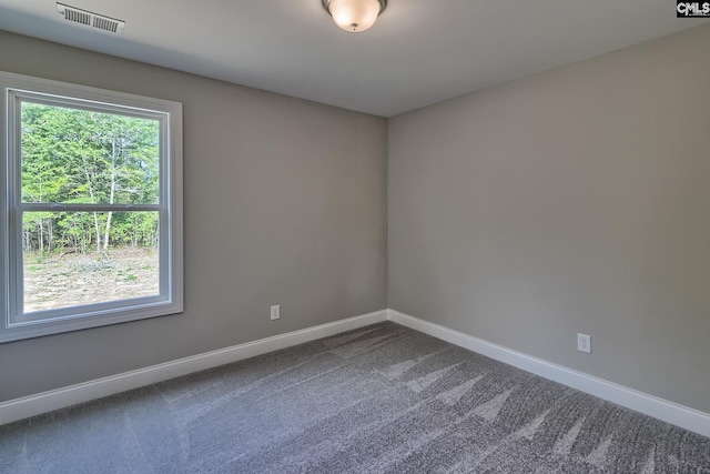 carpeted empty room with visible vents and baseboards