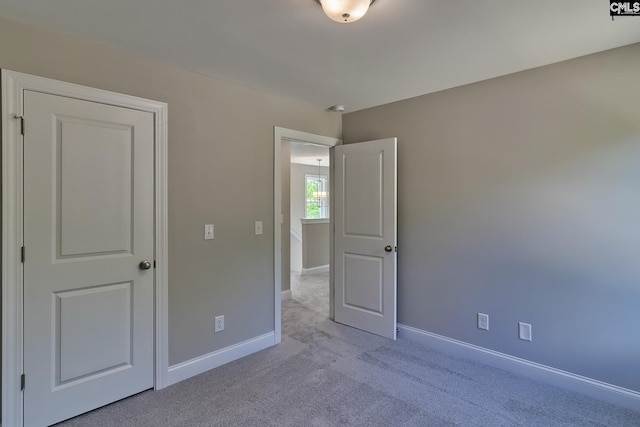 unfurnished bedroom with baseboards and carpet floors