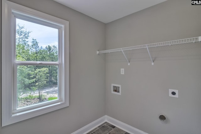 clothes washing area featuring baseboards, washer hookup, laundry area, plenty of natural light, and electric dryer hookup