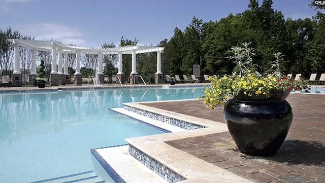 community pool featuring a pergola