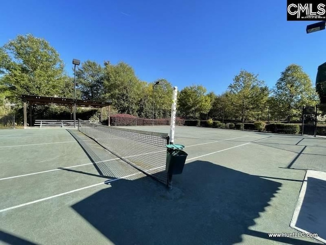 view of tennis court featuring fence