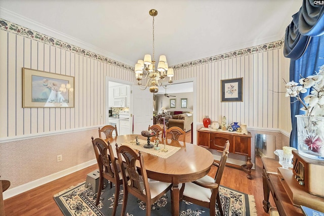 dining area with wallpapered walls, baseboards, light wood-type flooring, and a chandelier