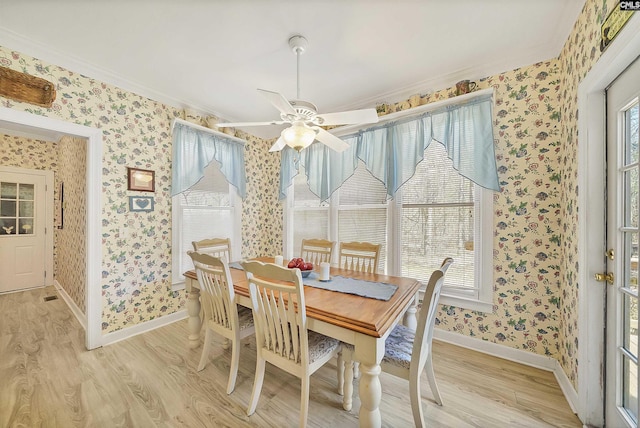 dining room with baseboards, light wood-style flooring, and wallpapered walls