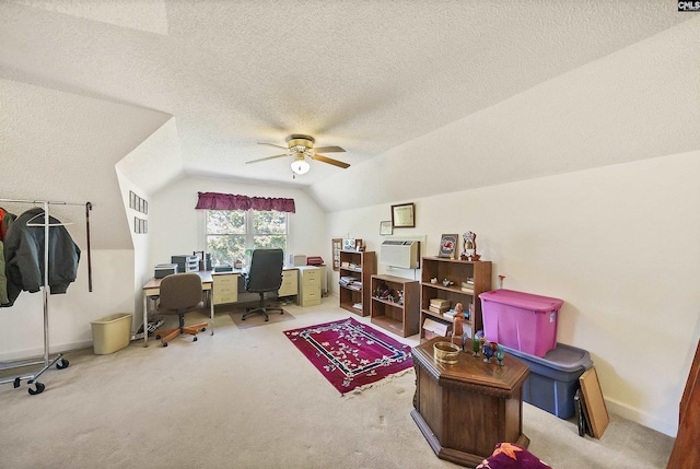 carpeted office space with baseboards, a textured ceiling, ceiling fan, and vaulted ceiling