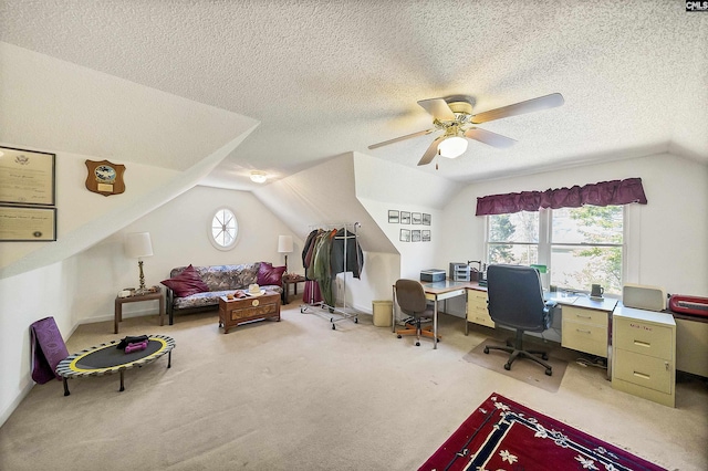 home office with ceiling fan, vaulted ceiling, a textured ceiling, and light carpet