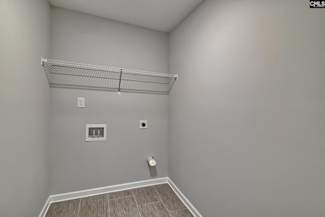 laundry room featuring baseboards, wood finish floors, laundry area, hookup for a washing machine, and hookup for an electric dryer