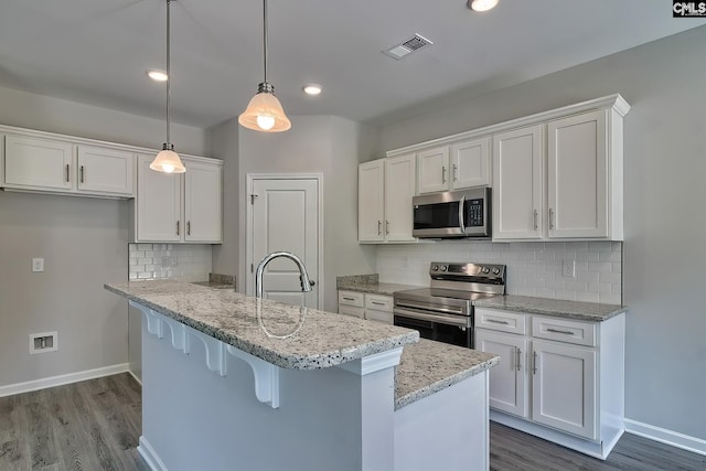 kitchen featuring baseboards, visible vents, a sink, white cabinets, and appliances with stainless steel finishes