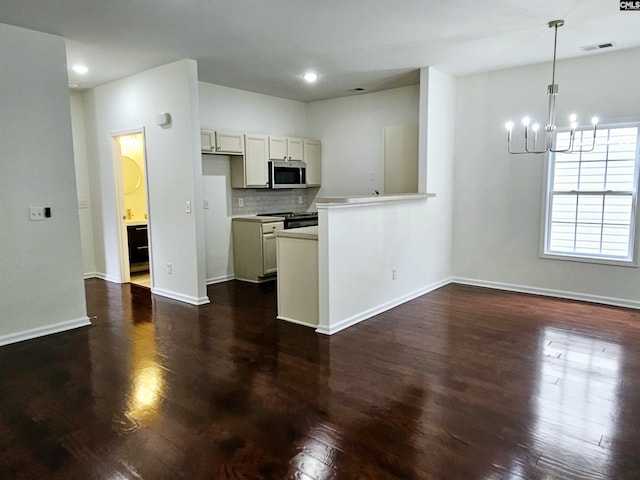 kitchen with visible vents, stainless steel microwave, tasteful backsplash, dark wood-style floors, and black / electric stove