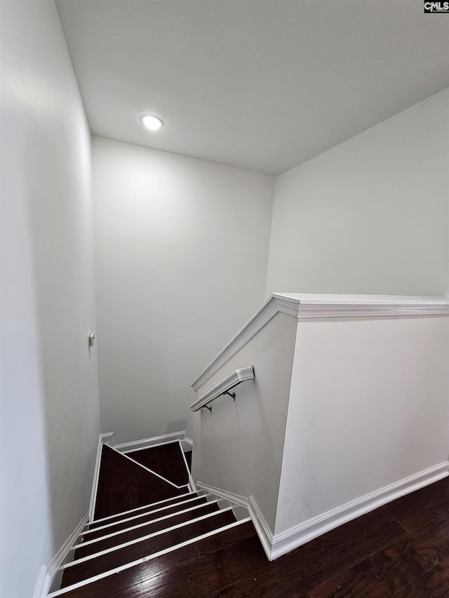 staircase featuring recessed lighting, baseboards, and wood finished floors