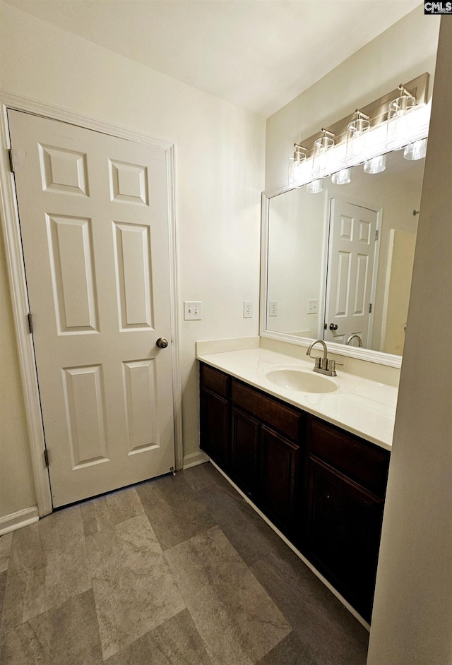 bathroom with vanity and baseboards