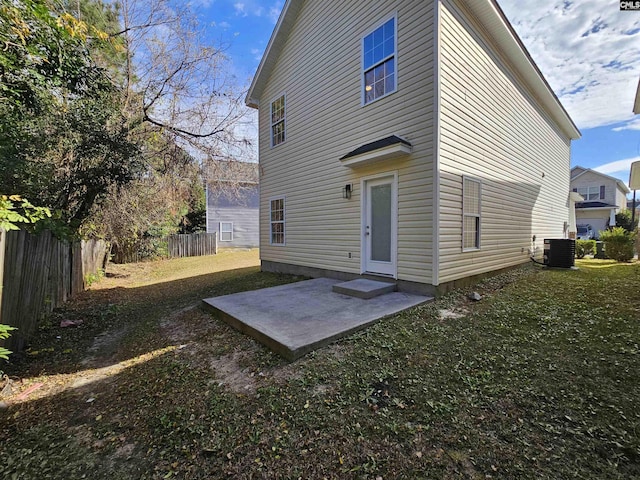 back of house with a patio area, a lawn, central AC unit, and fence