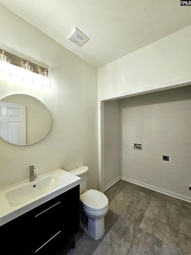 bathroom with vanity, toilet, baseboards, and visible vents